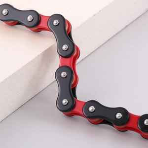 Macro shot of red and black bicycle-style motorcycle chain link bracelet for men