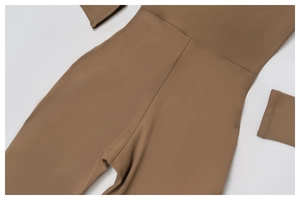 Close-up of stitching and waist seam details on a brown thermal yoga jumpsuit