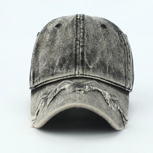 Detailed macro view of vintage distressed denim baseball cap with frayed brim edges