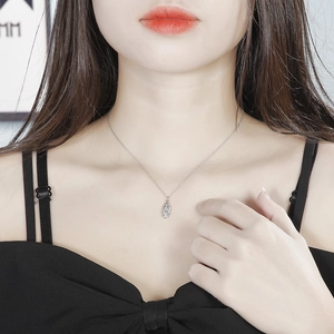 Close-up of a vintage steel pendant necklace featuring an embossed religious portrait
