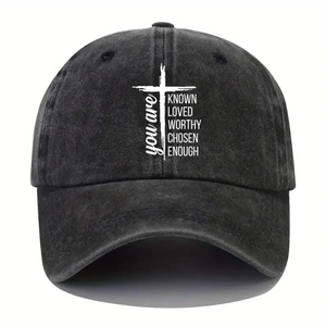 Close-up of printed cross and motivational text on vintage washed denim baseball cap