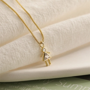 Detailed view of a gold girl pendant necklace with sparkling clear triangular gemstone