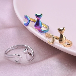 Adjustable cat rings in silver gold and rainbow stainless steel on silk background