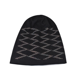 Detail view of black knit beanie featuring geometric rhinestone patterns on warm fabric