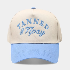 Minimalist beige and blue baseball cap featuring TANNED & Tipsy embroidery detail