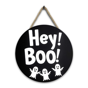 Detail of round black Halloween wood sign with Hey Boo text and cute ghosts
