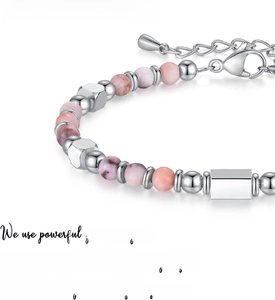 Macro detail of Pink Zebra Jasper beaded bracelet with silver lobster clasp and text
