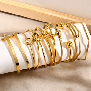 Collection of various 18K gold plated stainless steel knot and geometric cuff bracelets