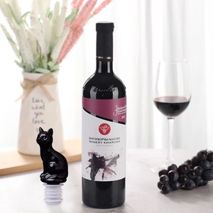 Elegant black cat wine bottle stopper shown in a stylish home setting with vineyard props