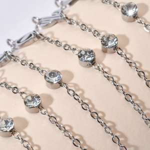 Minimalist silver stainless steel bracelet featuring delicate chains and sparkling zircons