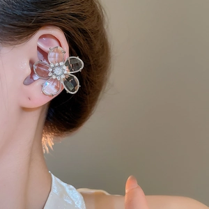 Close-up of elegant zircon flower ear cuff on model showing delicate crystal petals