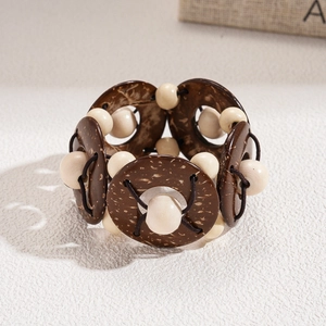 Detail of retro wooden beads and coconut shell flower bracelet with elastic string