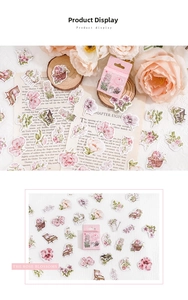 Close-up of vintage floral stickers with pink roses and garden illustrations for DIY scrapbooks