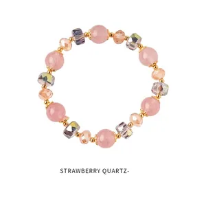 Detail of strawberry quartz beads with golden spacers on a stylish beaded bracelet