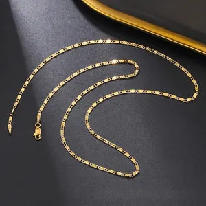 Macro shot of gold flat chain with diagonal cut texture and lobster clasp on black background