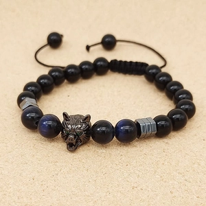 Detail of beaded bracelet with tiger eye stones, obsidian beads, and black metal wolf head