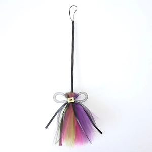 Detail of Halloween witch broom featuring colorful mesh tulle and sparkly gold buckle