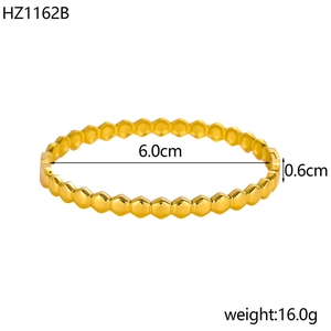 Macro view of gold 18K plated bangle with hexagonal texture showing 6.0cm inner diameter