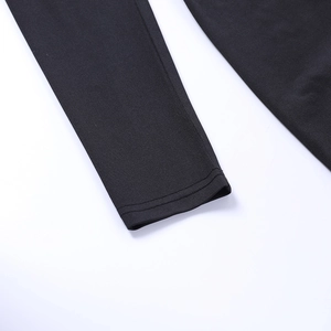 Close-up detail of double-needle stitching on black elastic knitted fabric bodysuit sleeve