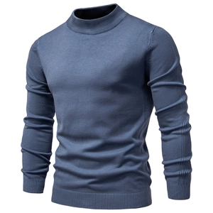 Detailed knit texture of a men's slim fit blue mock neck sweater for winter warmth