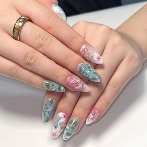 Pastel floral press-on nails in almond shape with blue pink gradient and 3D bead decor