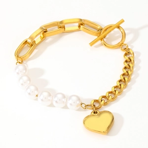 Golden chunky chain pearl bracelet with heart pendant and OT toggle clasp on white background