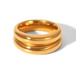 Detail of a minimalist gold double-layer thick ring with a polished mirror finish