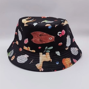 Close-up of animal and forest print details on a black reversible bucket hat