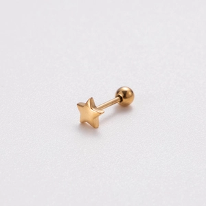 Macro shot of gold-plated stainless steel star stud earring with a screw back ball