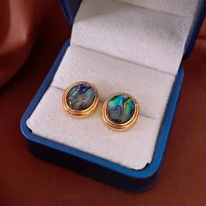 18K gold plated oval abalone shell stud earrings presented in a blue velvet jewelry box