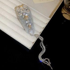 Macro view of crystal teardrop tassel hairpin with gray velvet texture base