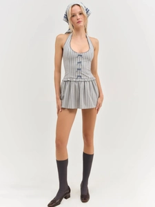 Detail of blue striped halter neck dress featuring a waist-defining fit and ruffled hem