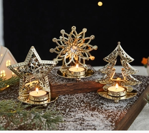 Close-up of golden hollow metal Christmas candle holders with star and tree designs