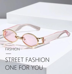 Detail of oval pink lenses and gold metal frames with wide gradient temples
