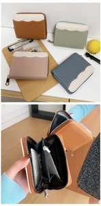 Detail of multi-color leather wallets showing internal card slots and zipper pocket layout
