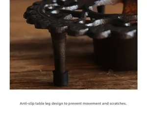 Close-up of cast iron warmer with non-slip rubber caps to protect wooden tabletop surfaces