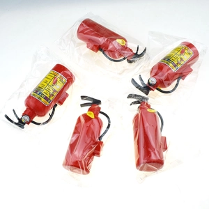 Detail shot of five mini fire extinguisher water guns in transparent polybag packaging