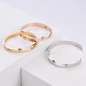 Detailed close-up of triple spike bracelets in gold, silver, and rose gold finishes