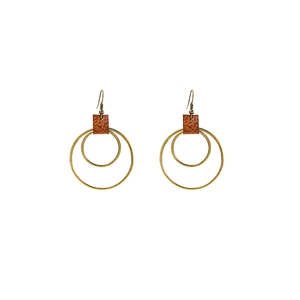 Detail of bohemian drop earrings with bronze metal rings and brown leather textured studs