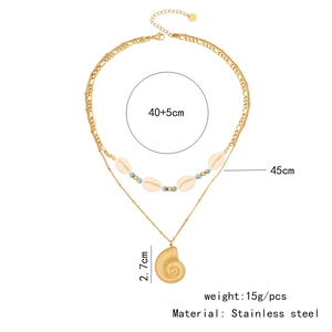 Detailed view of bohemian double-layer gold stainless steel necklace with shell pendants