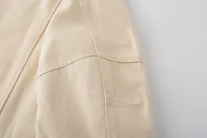 Close-up of beige canvas jacket showing detailed topstitching and heavy fabric texture