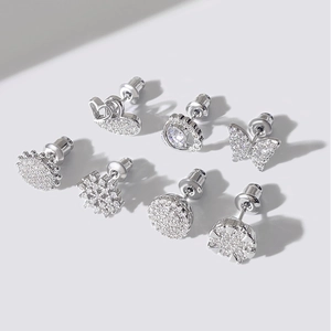 Detailed set of seven silver stud earrings featuring cubic zirconia in various shapes