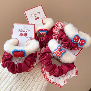 Set of four plush red hair scrunchies with white faux fur edges and cute resin charms