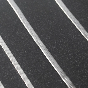 Detailed macro view of silver titanium steel snake chain with a flat blade weave texture