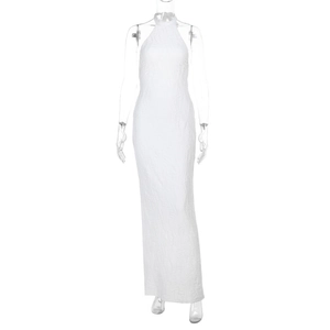 Close-up of textured fabric and backless halter design on a white maxi dress