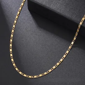 Close-up of golden stainless steel flat chain with alternating rectangular links and rings