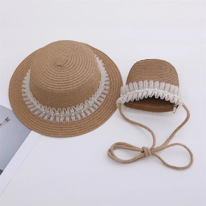 Close-up of children straw hat and matching bag with lace ruffles and white pearls