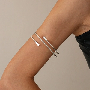 Silver hammered metal cuff bracelet on woman's arm with adjustable minimalist design