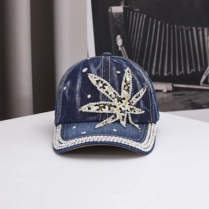 Blue denim baseball cap with rhinestone cannabis leaf pattern and pearl accents