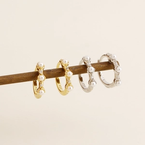 Close-up of gold and silver S925 sterling silver pearl hoop earrings with zircon